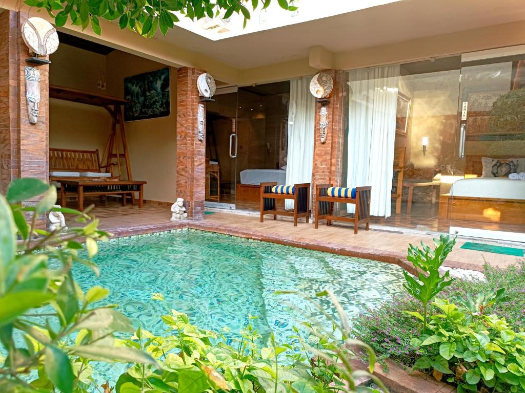 a swimming pool in the backyard of a house at Southern Bali Villa in Nusa Dua