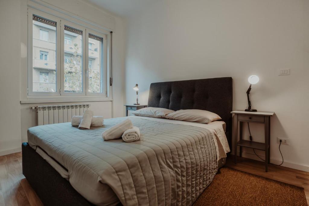 a bedroom with a large bed with two pillows on it at Elettra's studio x4 totally renovated in Trieste