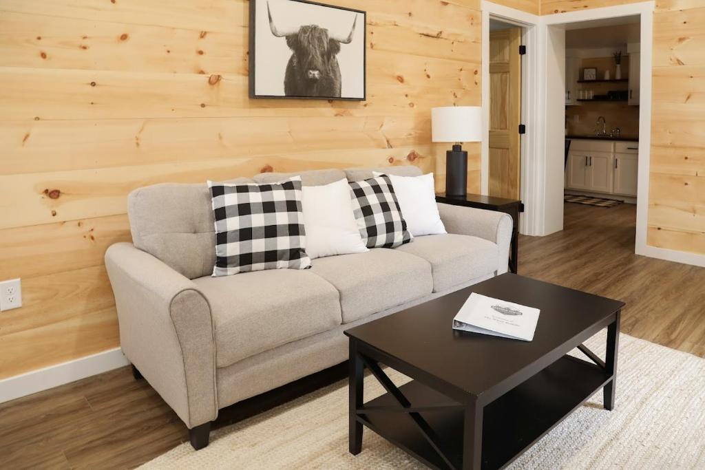 a living room with a couch and a table at Hartman Center Campground in Milroy