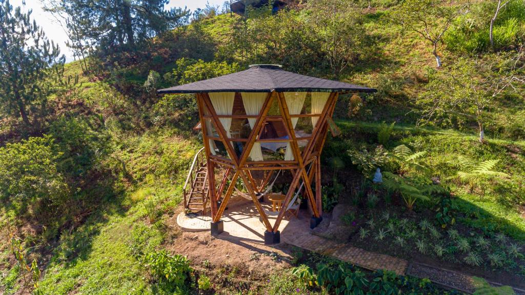 an aerial view of a tree house on a hill at Glamping Corazón del Molino in Ubaque