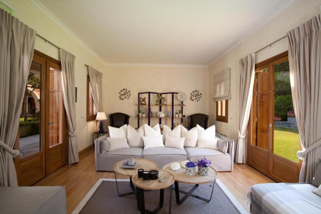 a living room with a couch and a table at Villa Veneziano Suites & Villa in Nydri