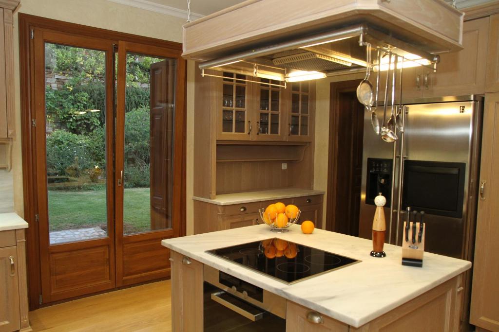 a kitchen with a sink and a stove top oven at Villa Veneziano Suites & Villa in Nydri