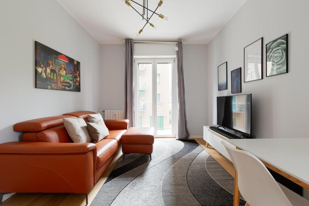 a living room with a couch and a television at GuestHost - Cimiano M2 Balcony Apartment in Milan