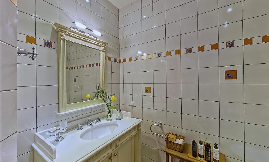 a bathroom with a sink and a mirror at Villa Veneziano Suites & Villa in Nydri