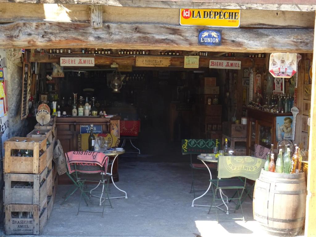 a store with tables and chairs in a building at Le Clos Fleuri in Caumont