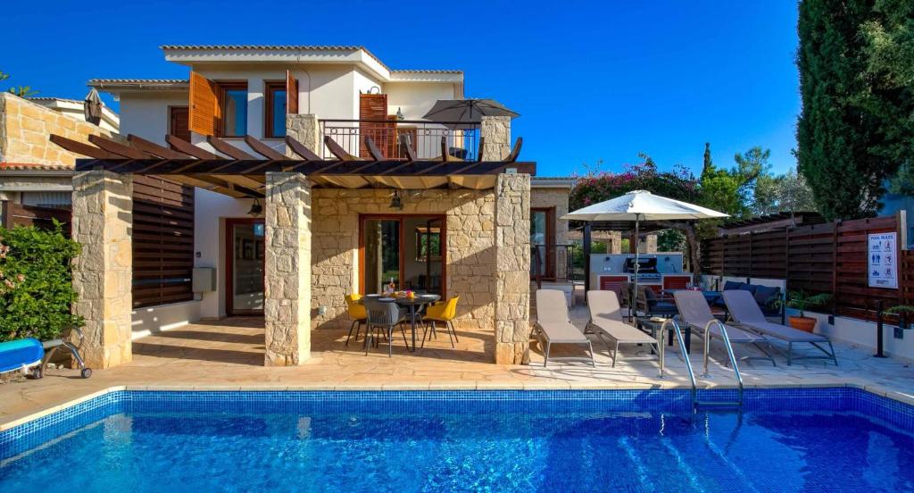 uma villa com uma piscina e uma casa em Villa HG21 Olympus em Kouklia