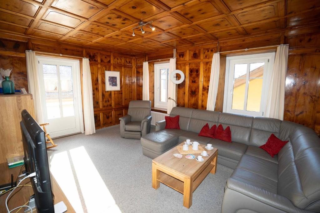 a living room with a couch and a table at Villa Hartenfels 2 in Scuol