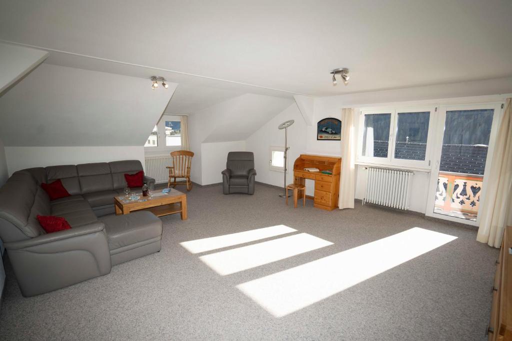 a living room with a couch and a table at Villa Hartenfels 3 in Scuol