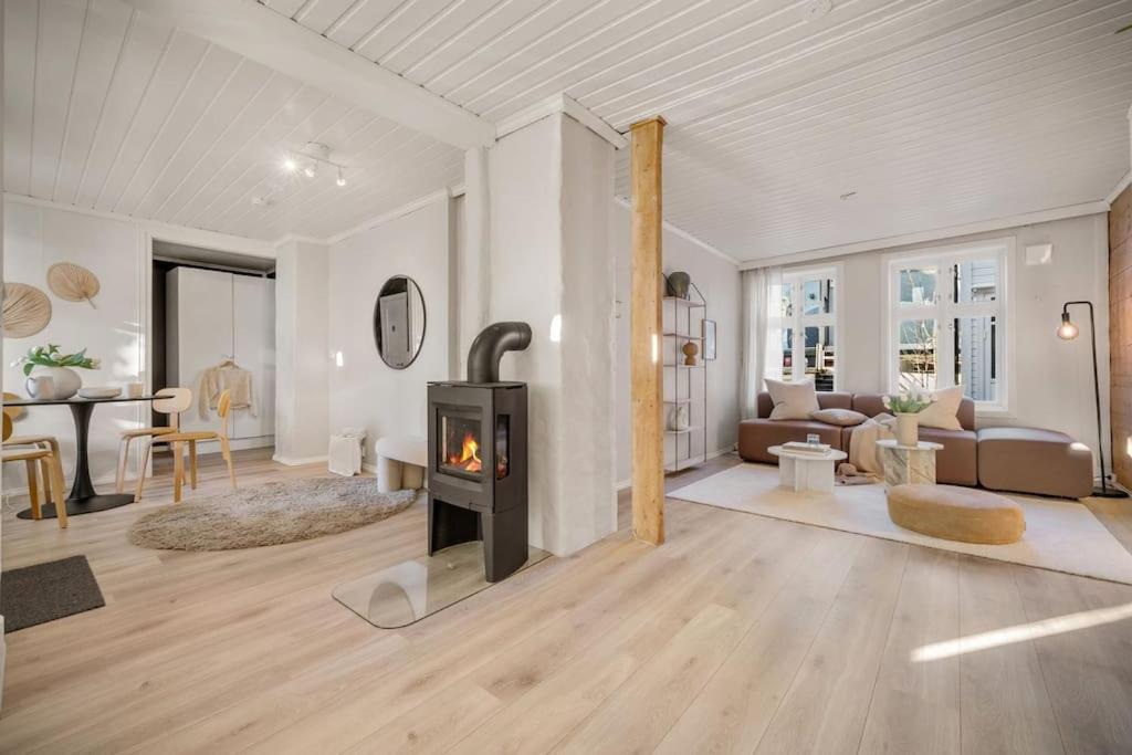 a living room with a wood stove in it at Central first floor apartment in Bergen