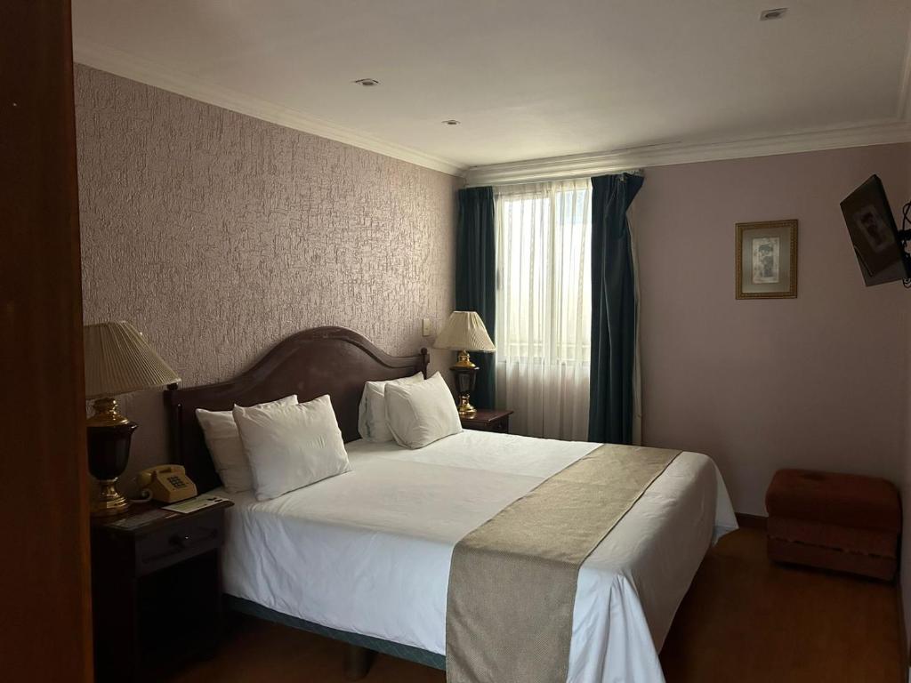 a hotel room with a bed and a window at HOTEL VIRREYNAL in Teziutlán