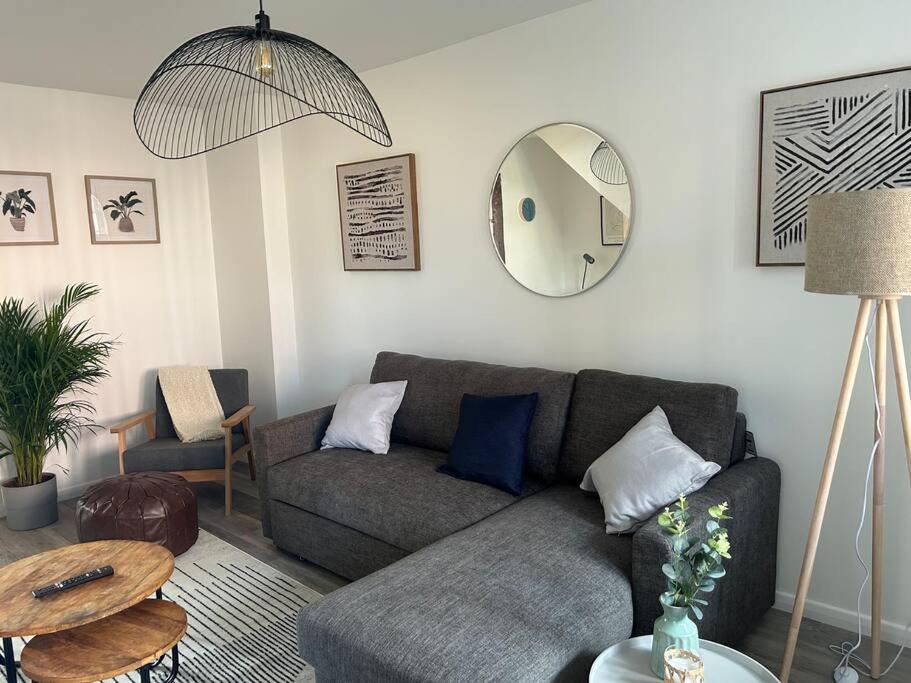 a living room with a couch and a mirror at Atlantic House, Walking Distance to Cardiff Bay and City Centre with Parking in Cardiff