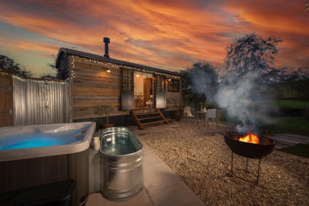 a house with a hot tub and a fire pit at Willow, Devon Heaven Hideaways, Nr Exeter in Kenton