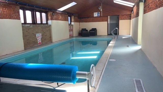 a large swimming pool in a building at The Granary in Tunstead