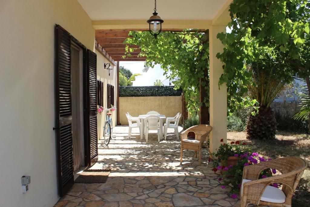 a patio with a table and chairs and an open door at Fiordilavanda in Martina Franca