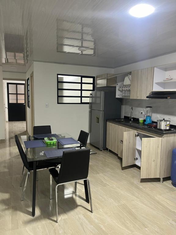 a kitchen with a table and chairs in a room at Apartaestudio en la mesa in La Mesa