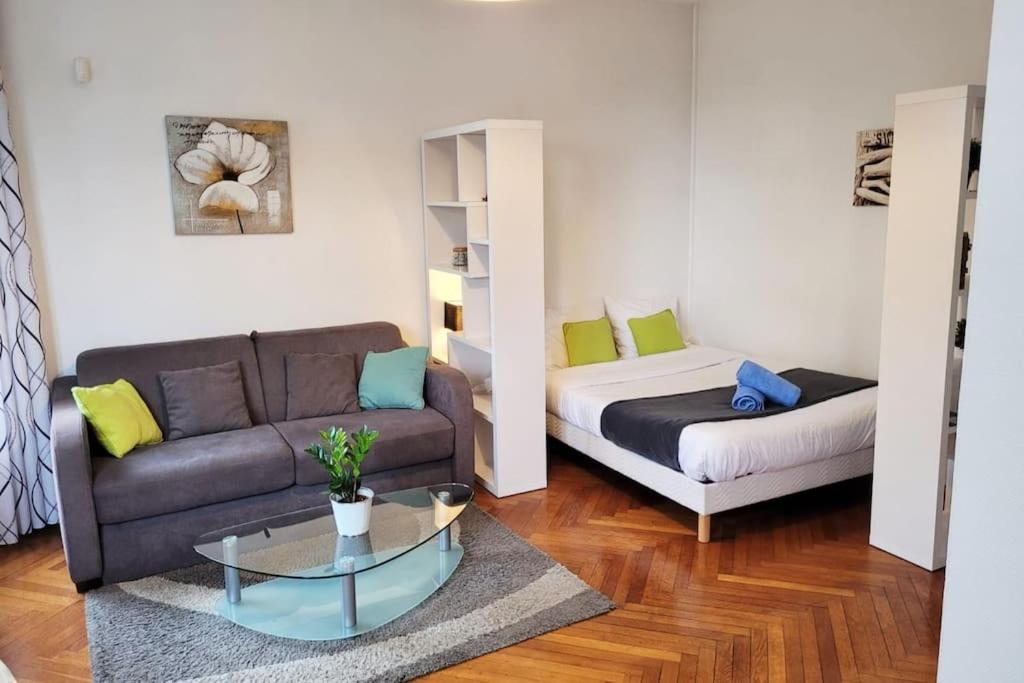 a living room with a couch and a coffee table at Le lumineux - Appartement central sur parquet chevrons - Chez Lulu in Nantes