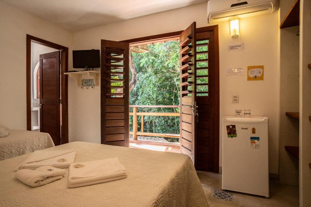 Postel nebo postele na pokoji v ubytování Pipa Surf Yoga Apartamento e Suítes com cozinha completa