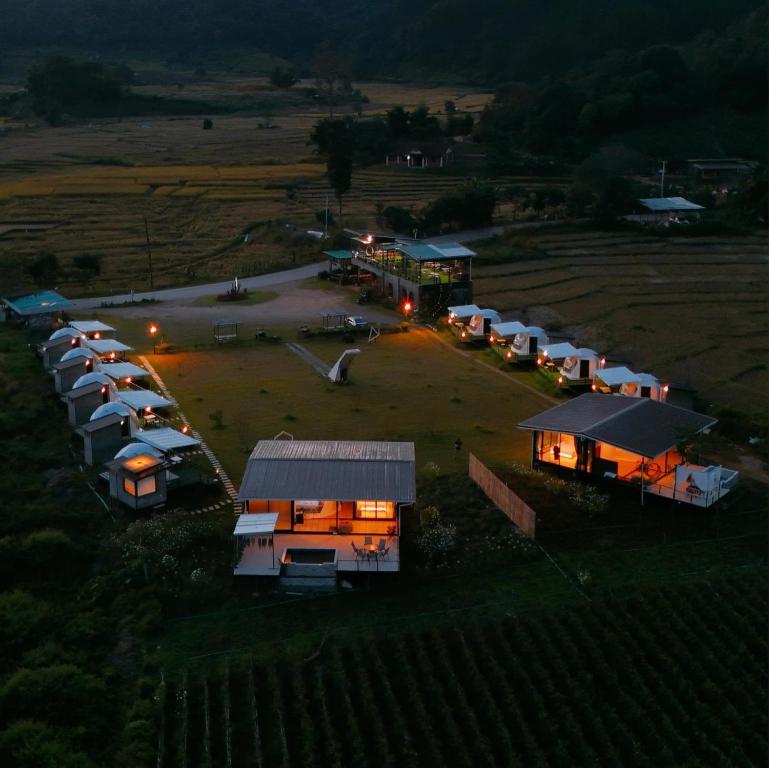 an aerial view of a row of tents in a field at WC Coffee&ไร่หวานซึ้ง in Mae Hong Son