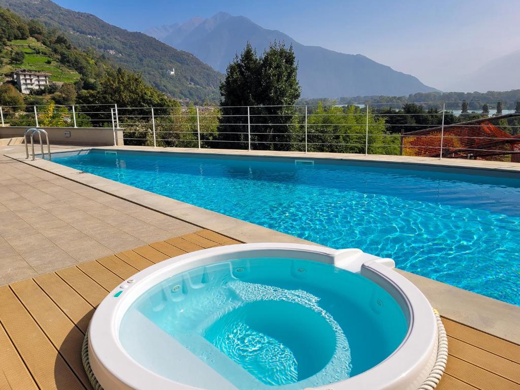 a large swimming pool with a large blue swimming pool at Vigna Panorama in Gera Lario