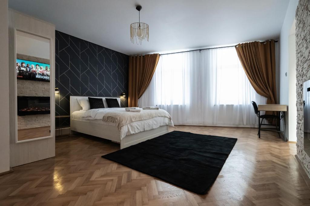 a bedroom with a bed with a black wall at Casa Basarab Brasov in Braşov