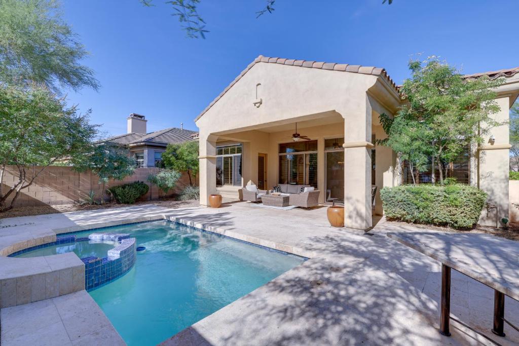 a swimming pool in front of a house at Spacious North Phoenix Oasis with Pool and Patio! in Phoenix