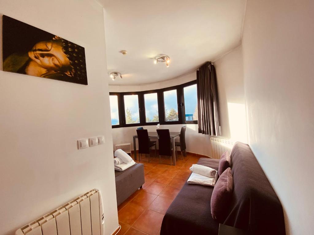 a living room with a couch and a table at Apartamentos Bluettravel Snow Confort Monte Gorbea in Sierra Nevada