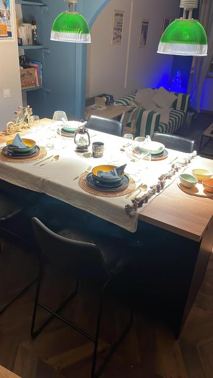stół z talerzami i naczyniami na górze w obiekcie L’appart chic gapençais w mieście Gap