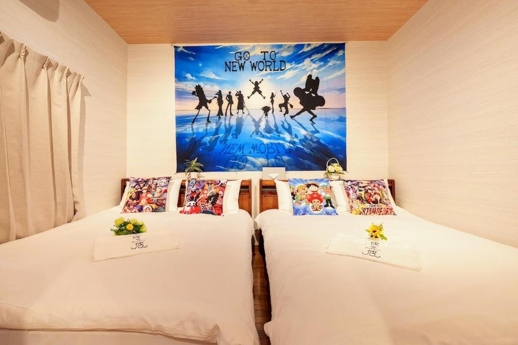 two beds in a room with a movie poster on the wall at Nakanishiso 2F - Vacation STAY 30052v in Tokyo