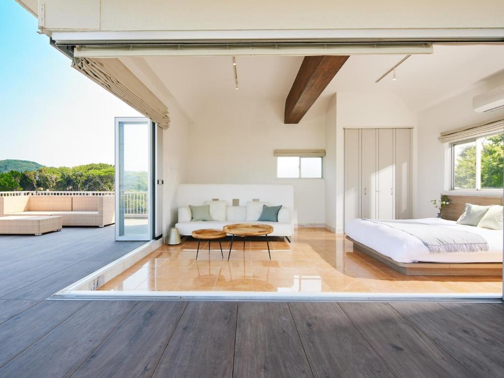 a bedroom with a bed and a couch and a table at SAJIMA Funny house - Vacation STAY 15436 in Hayama