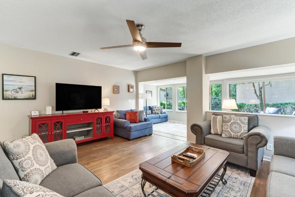 a living room with a couch and a tv at 3322 Fairway Oaks in Amelia Island