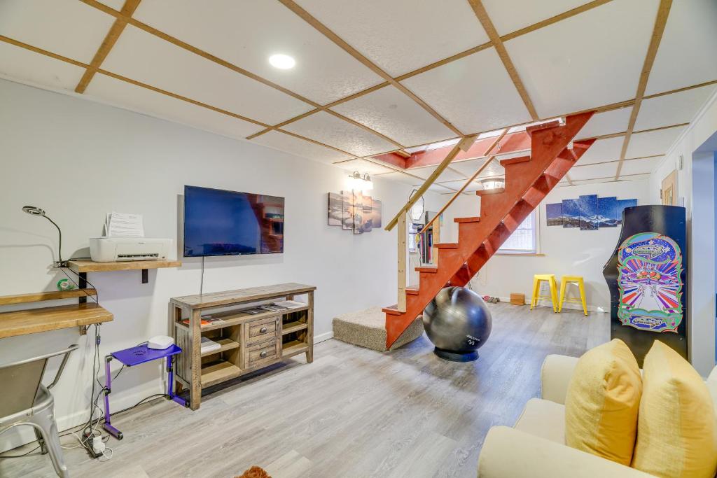 a living room with a couch and a staircase at Hot Tub and Resort Amenities Pocono Lake Retreat! in Pocono Lake