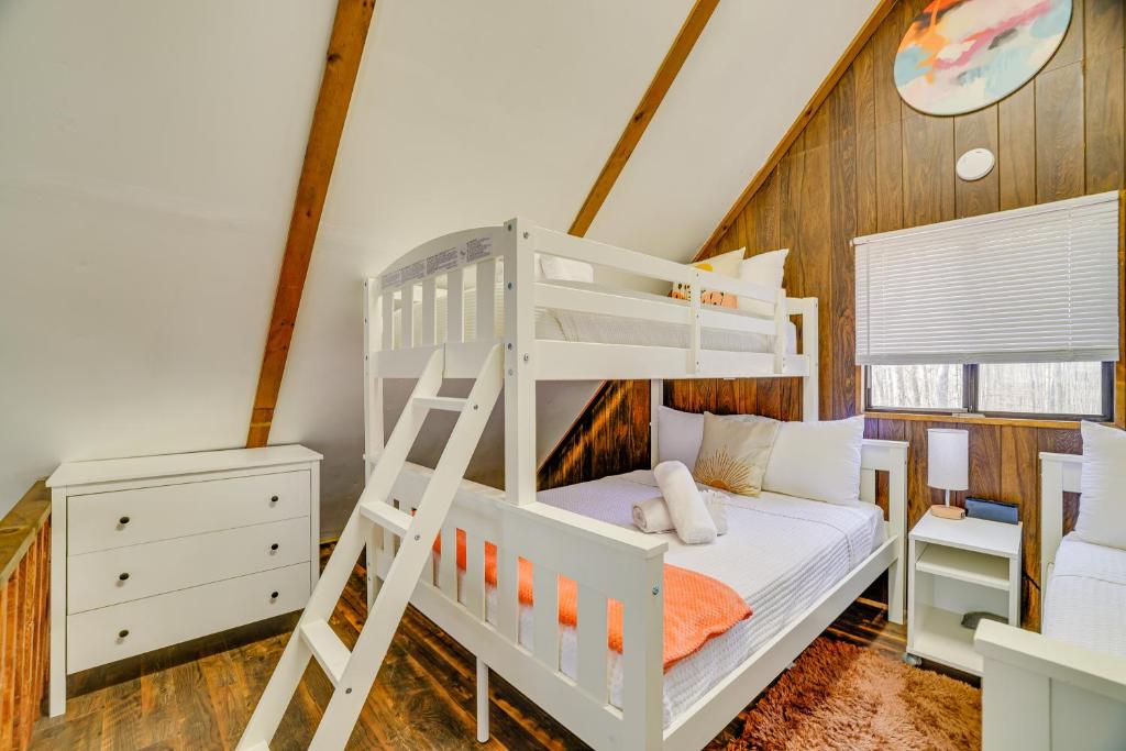a white bunk bed in a room with a ladder at Hot Tub and Resort Amenities Pocono Lake Retreat! in Pocono Lake