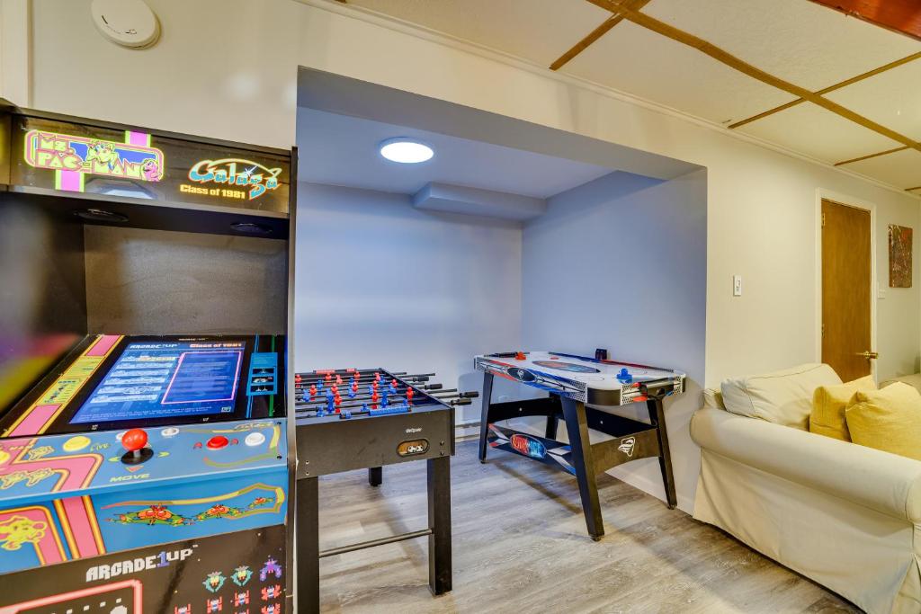 a room with a pinball machine and a table at Hot Tub and Resort Amenities Pocono Lake Retreat! in Pocono Lake