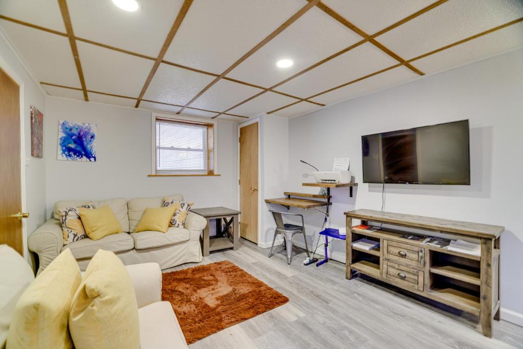 a living room with a couch and a flat screen tv at Hot Tub and Resort Amenities Pocono Lake Retreat! in Pocono Lake