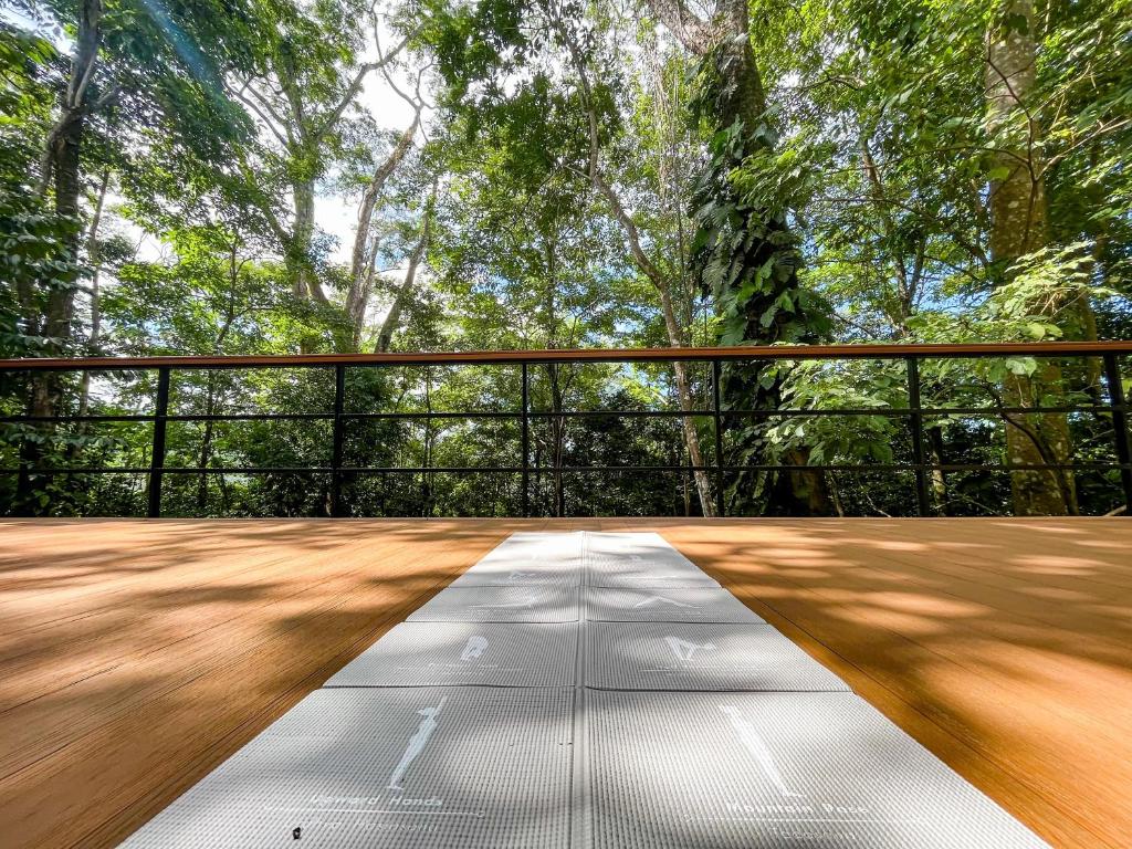 an empty deck with trees in the background at Selva Pacific Mountain Beach retreat in Quebrada Ganado