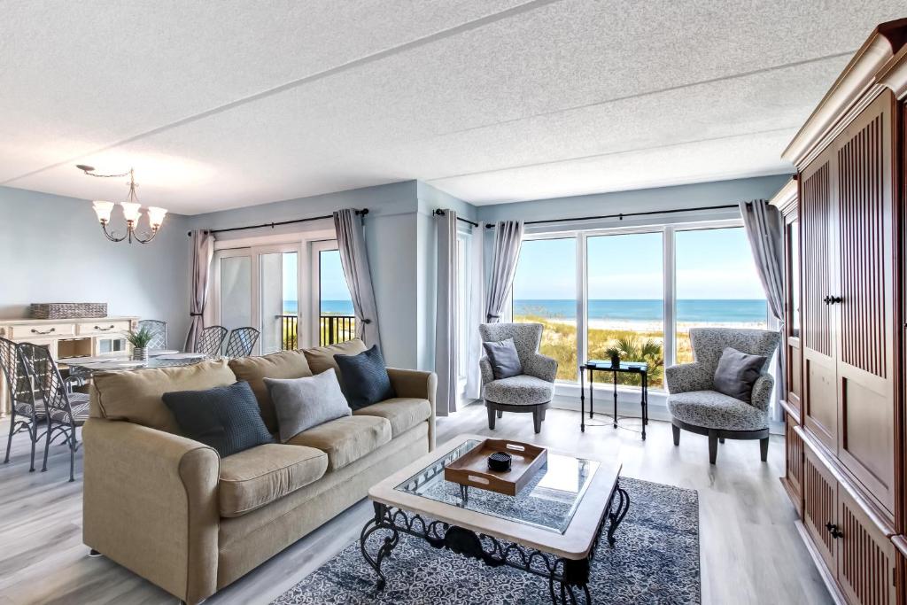 a living room with a couch and a table at 112 Oceans Of Amelia in Amelia Island