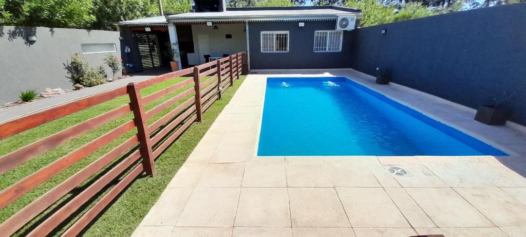 a swimming pool in the backyard of a house at Tranquilidad Total in Roldán