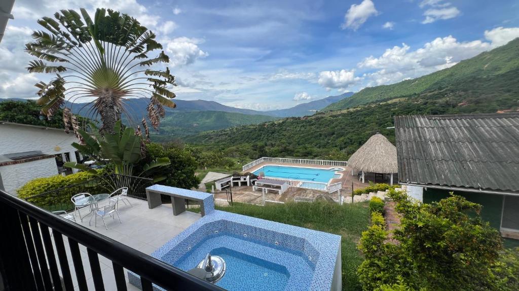 a pool on a balcony with a view of the mountains at Villa La Felisa Hospedaje Campestre Pandi Cundinamarca in Pandi