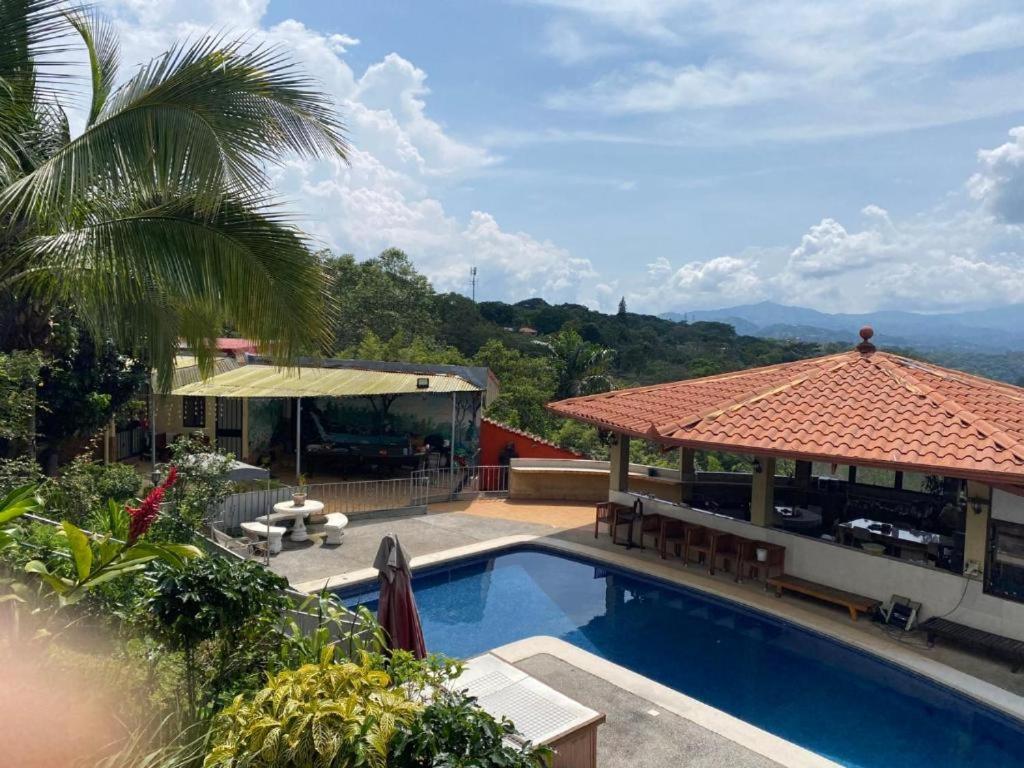 a house with a swimming pool and a pavilion at Garita Inn Delux in La Garita