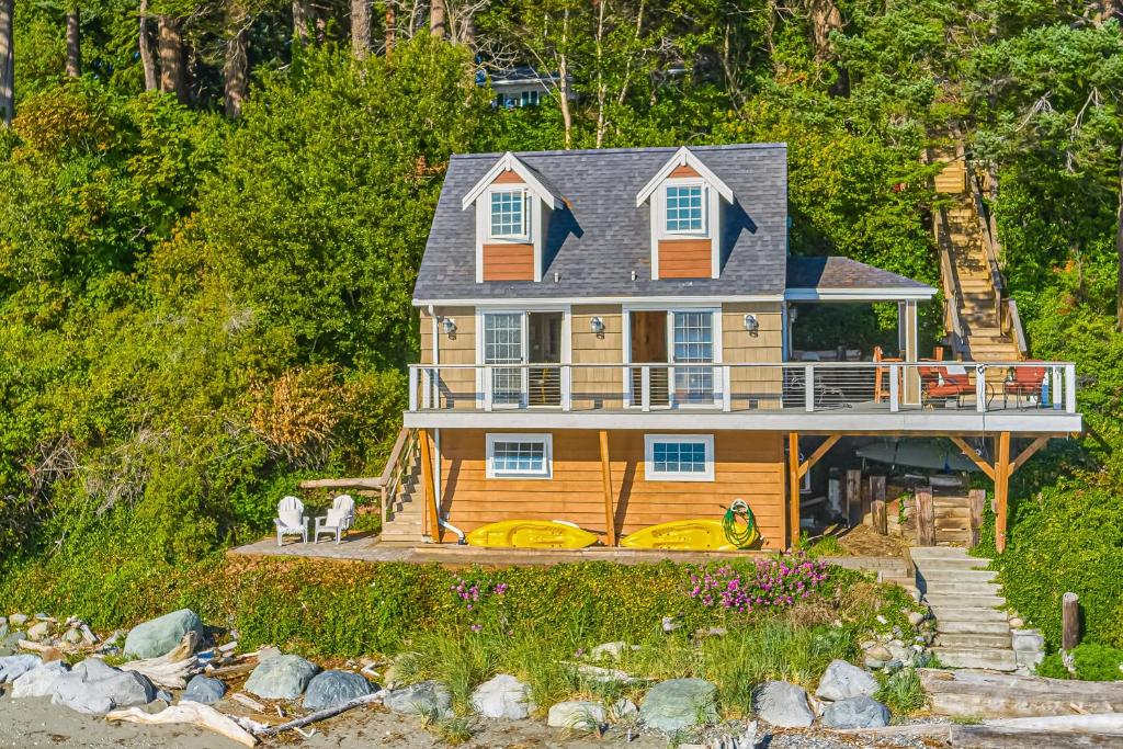 a large house with a porch and a deck at Ferry Viewer Cottage in Point Roberts