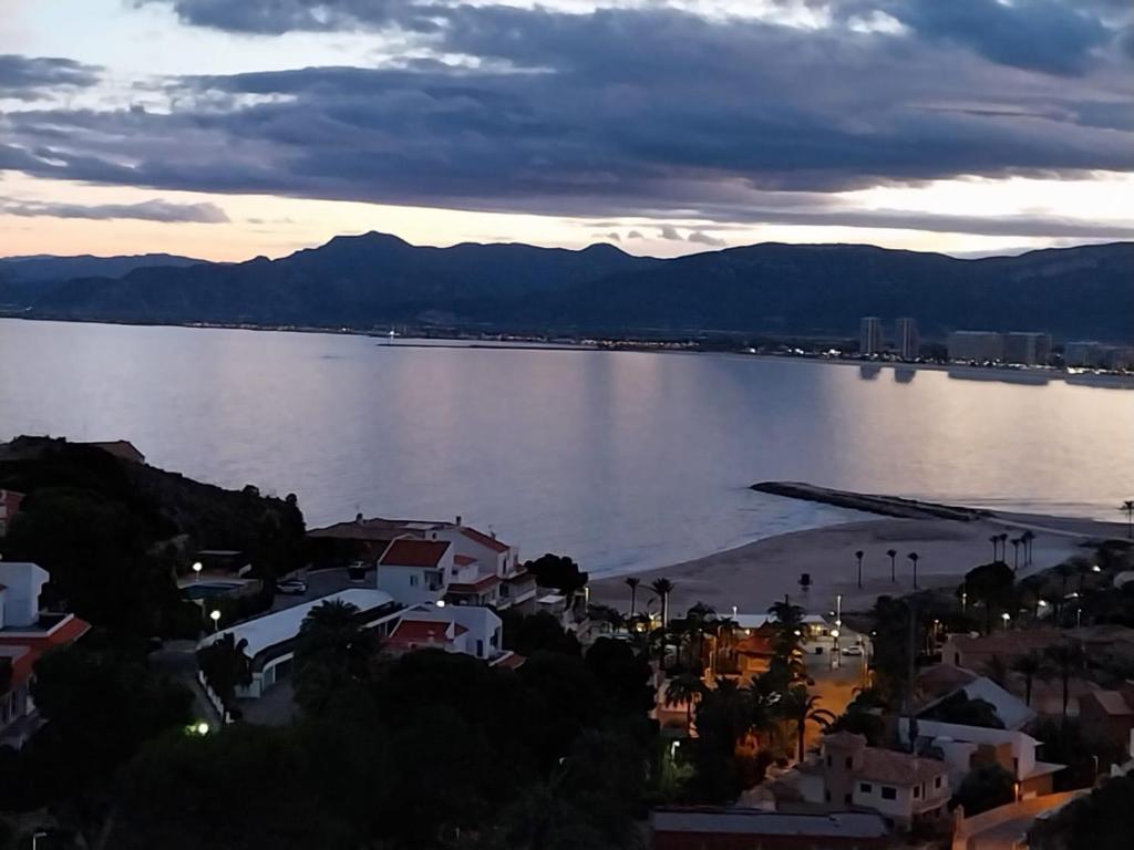 a view of a large body of water with a city at Apartamentos Bon Amb in Faro de Cullera