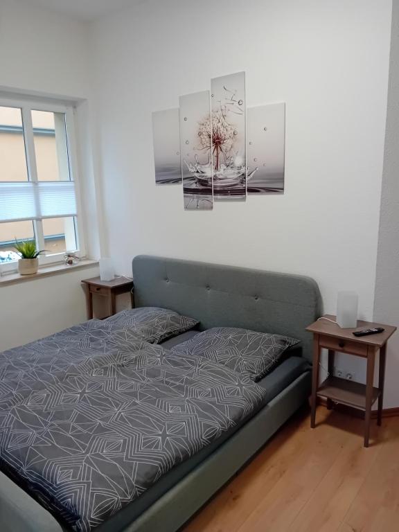 a bedroom with a bed and two tables at Top Ferienwohnung in sehr guter Lage in Dresden