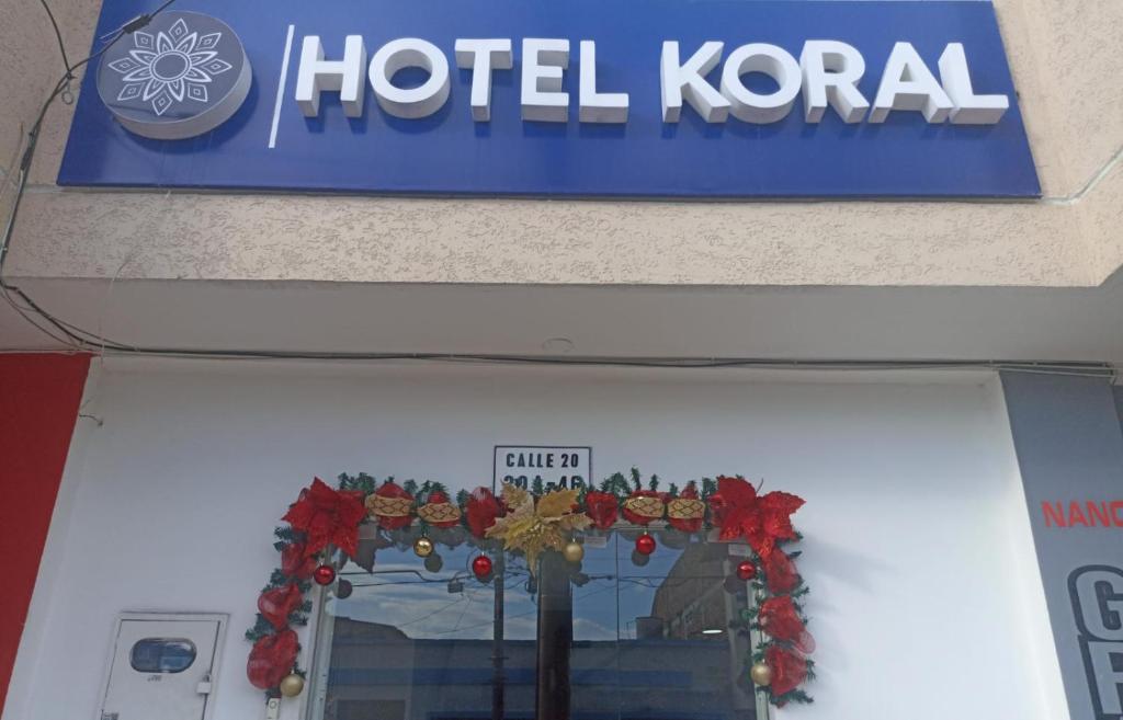 a hotel korean sign above a hotel korean door at hotel koral palmira in Palmira
