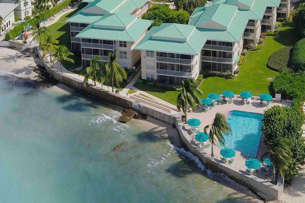 an aerial view of a resort with a swimming pool at Plantation Village # 64 Seven Mile Beach Fully Renovated Modern 2 Bed 2 Bath in George Town