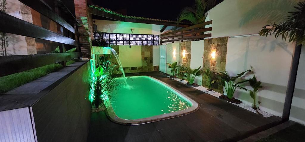 a swimming pool in a house with a water slide at Loft completo com area de lazer piscina e churrsqueira in Natal
