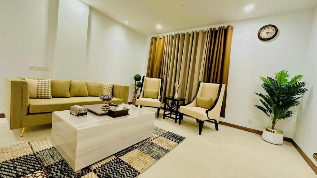 a living room with a couch and a table and chairs at Premium&Cozy One Bed DHA LHR in Lahore