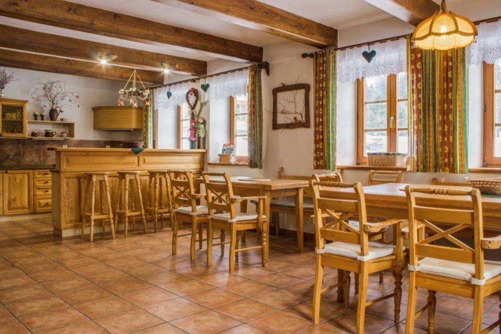 a dining room with a table and chairs at Třetí chalupa U Smrčiny in Janske Lazne