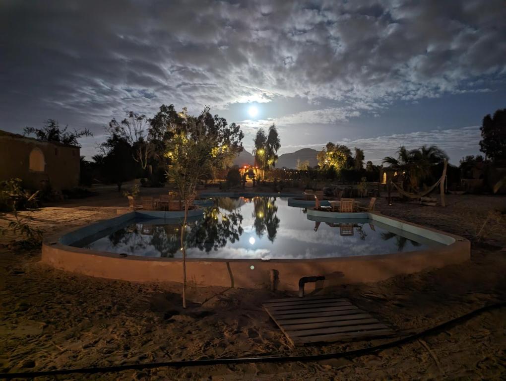 basen w środku pustyni w nocy w obiekcie Cafour House Siwa - Hot Spring w mieście Siwa