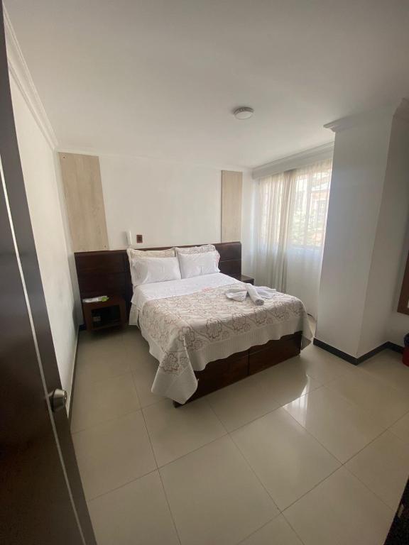 Postel nebo postele na pokoji v ubytování Hotel Yolima Real
