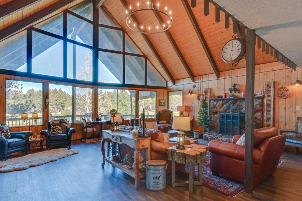 a living room filled with furniture and a clock at Munds Park Cabin with Deck and Golf Course Views in Munds Park